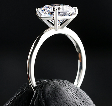 A diamond ring held between two fingers - Ingenuity Diamonds NEWS