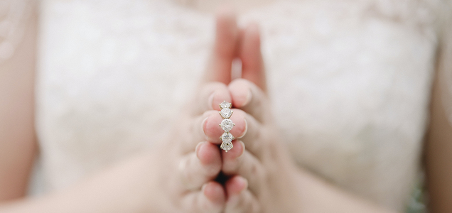 Woman in wedding dress showing diamond ring